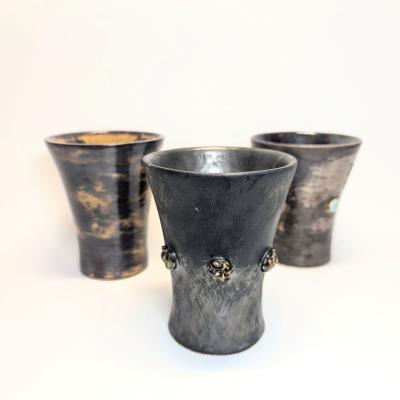 Three handcrafted funnel-shaped ceramic cups made on the pottery wheel, designed for water and wine, with a textured grip for easy handling.